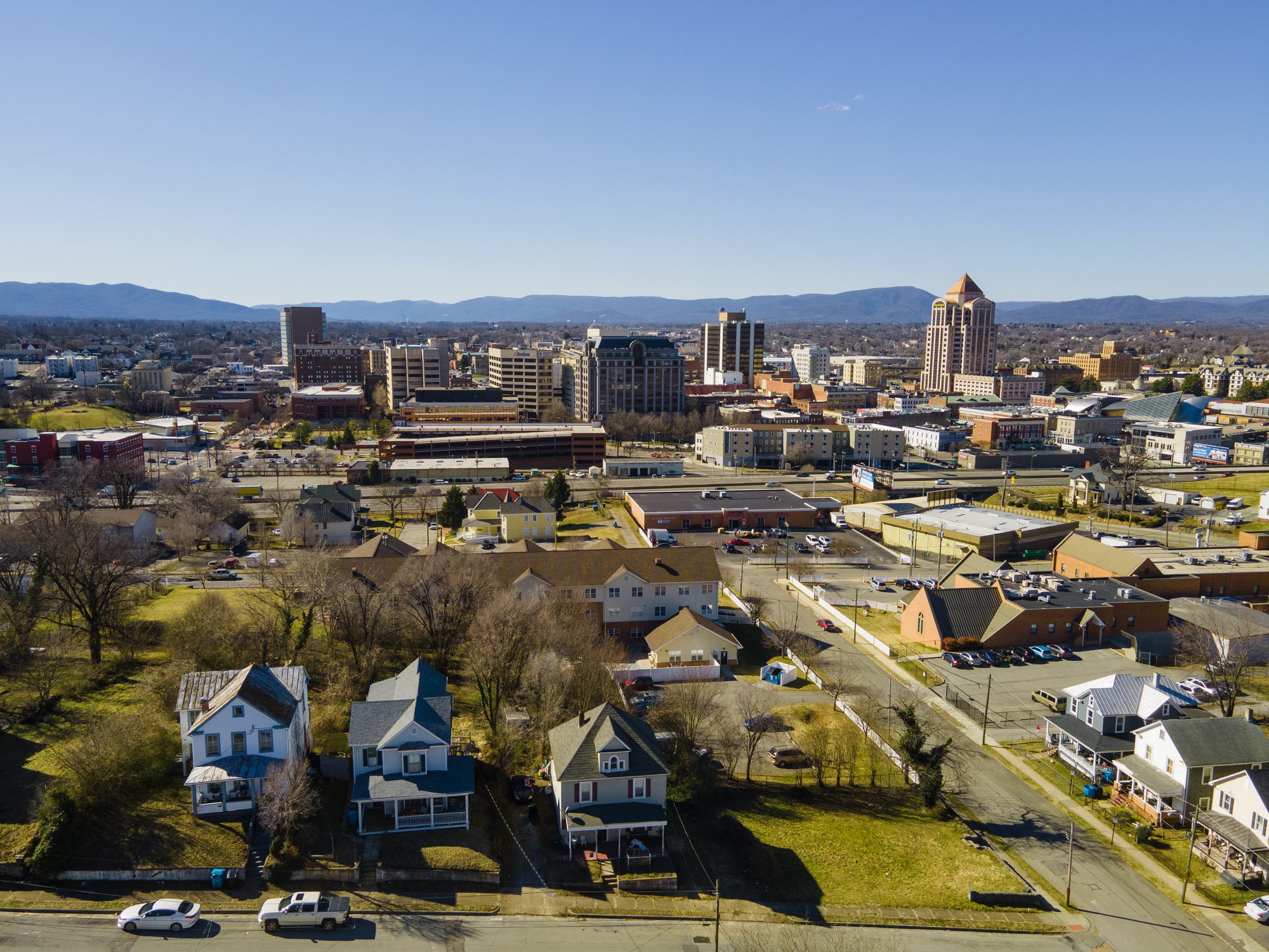 Aerial over Roanoke, Virginia Aerial view of Roanoke, Virginia skyline and foreground residential neighborhood with mature shade trees, illustrating local tree care and urban tree services provided by Southwest Virginia arborists.